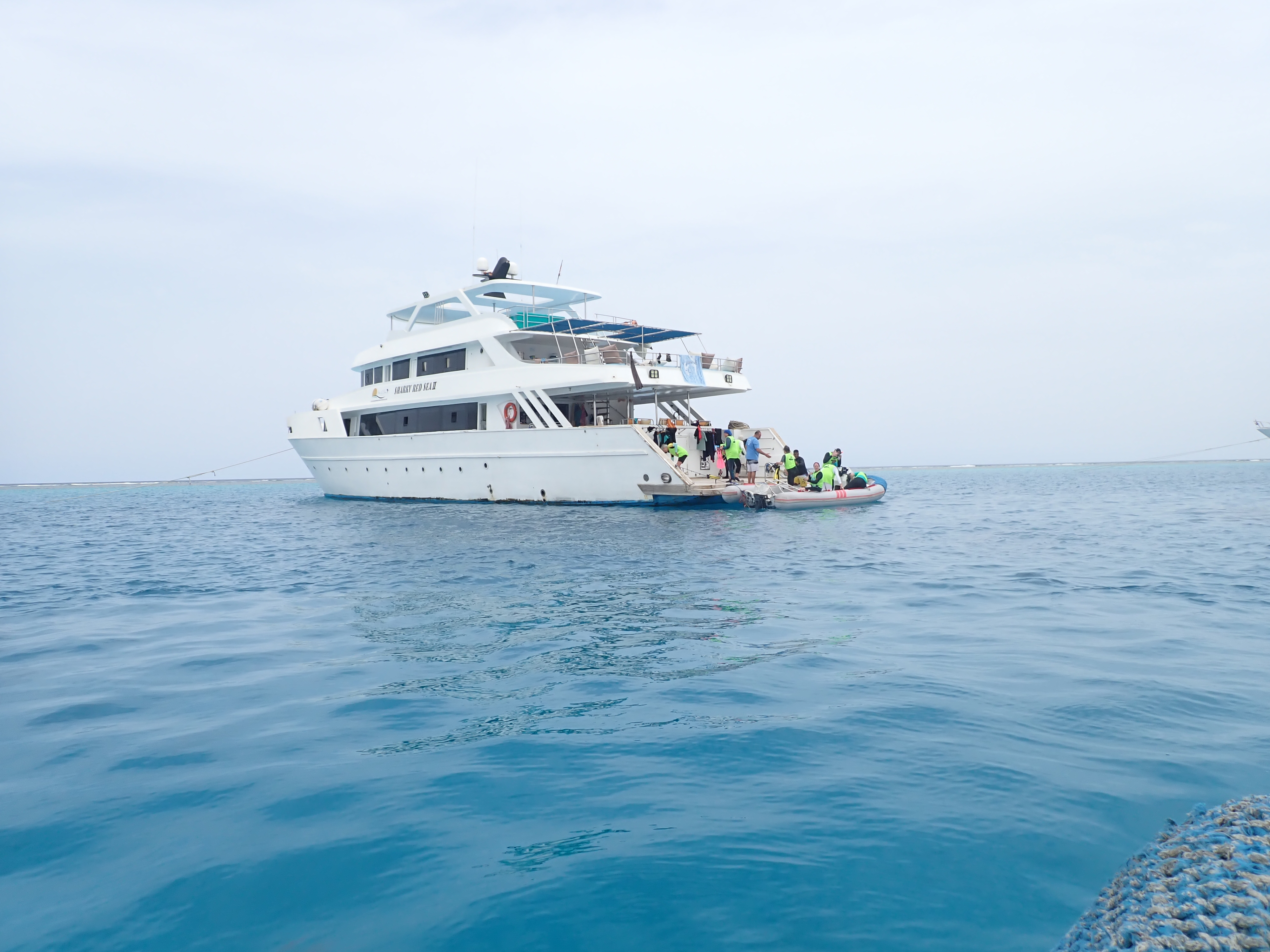 The Ocean Heart Retreat liveaboard boat with guests boarding the dinghy